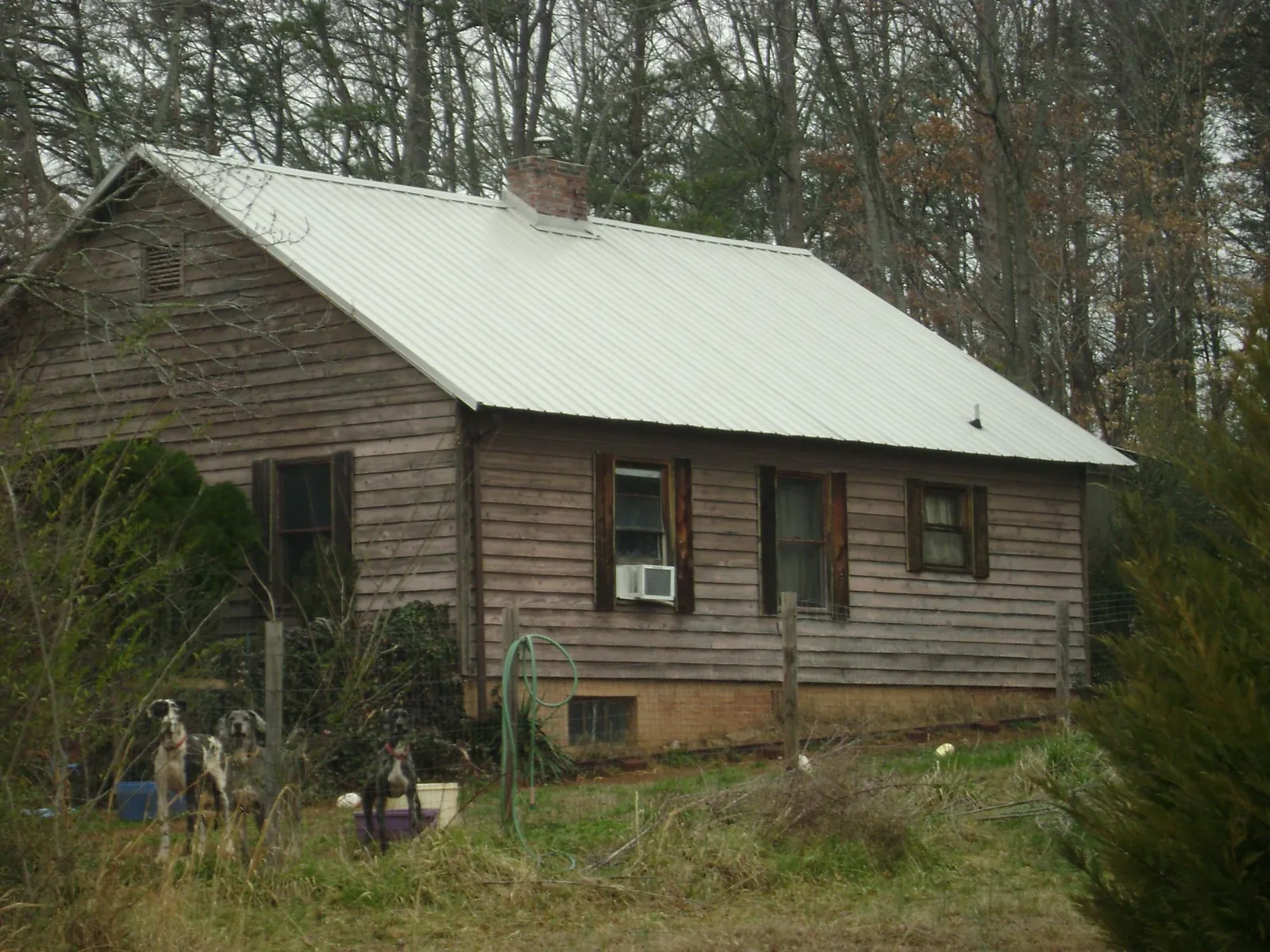 White metal roof on an old wood sided farmhouse, from a Metal Roof Installation job in Osterburg